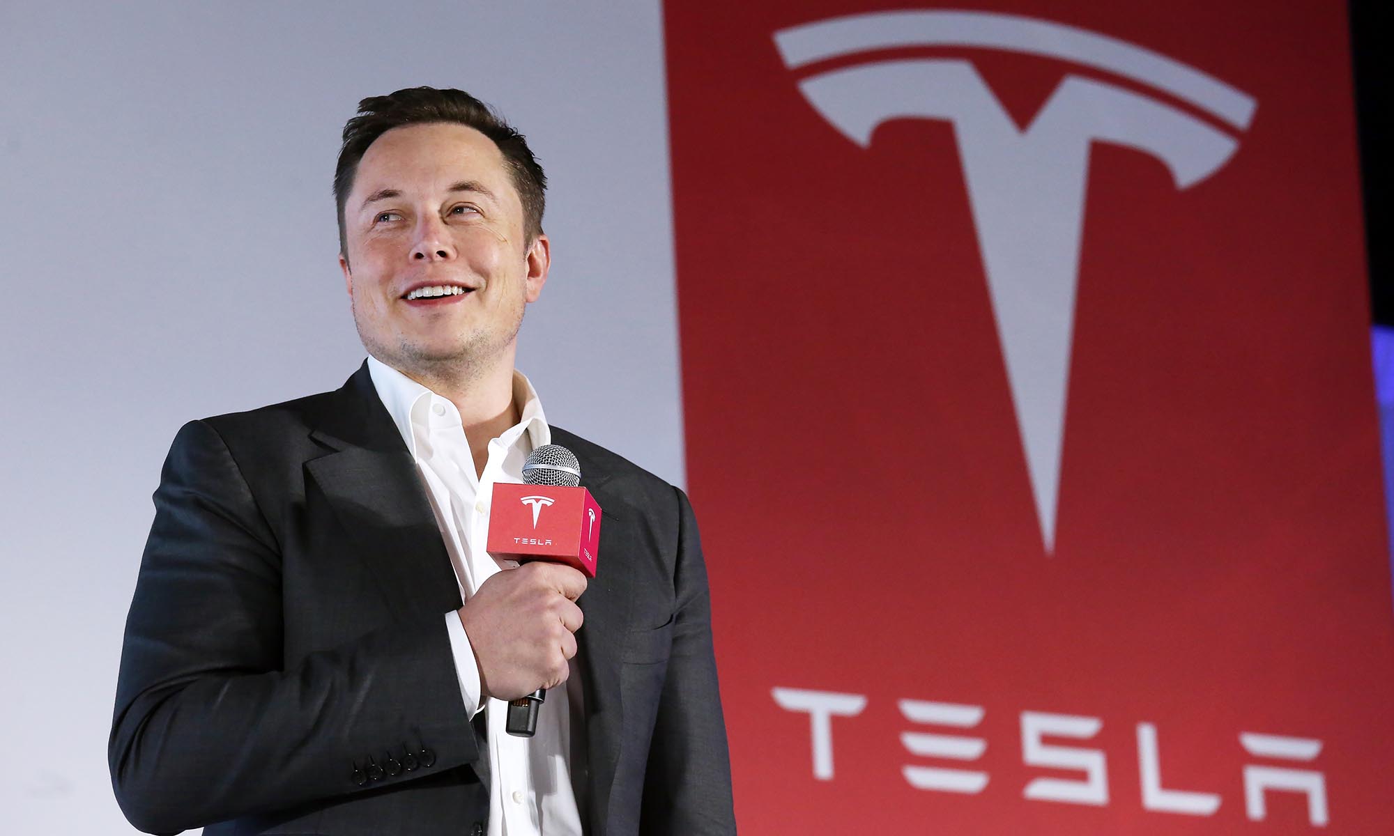 Tesla Motors CEO Elon Musk speaks to the media next to its Model S during a press conference in Hong Kong. 25JAN16 SCMP/ Nora Tam