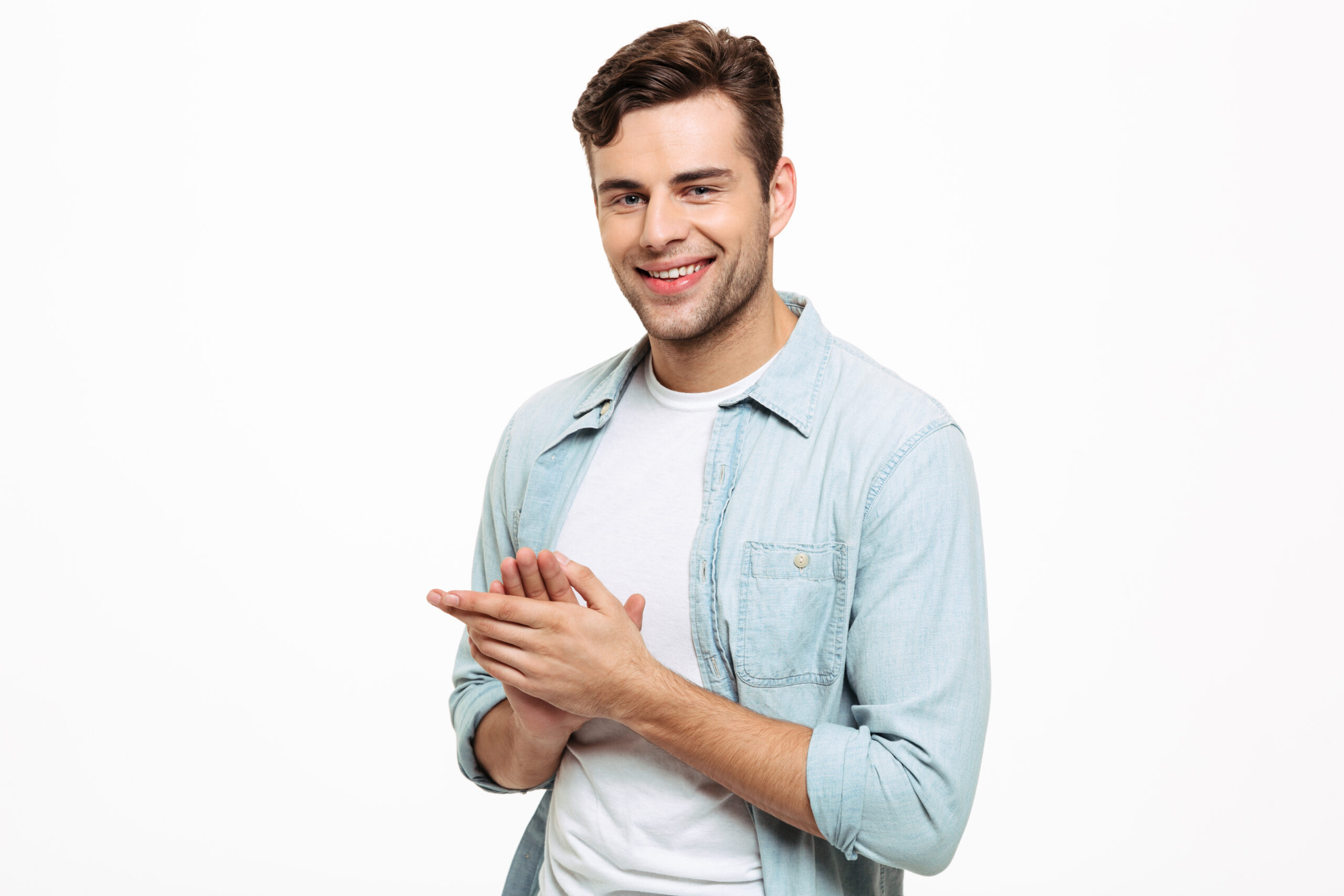 Portrait of a smiling young man rubbing his hands привітання з 20-річчям хлопцеві